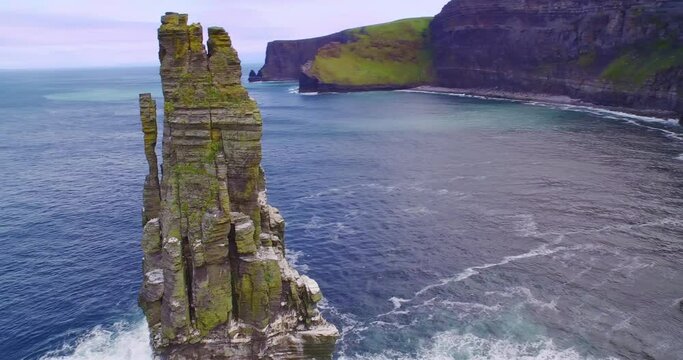 Aerial: Ocean, birds flying and rocky coastline. Cliffs of Moher, Ireland