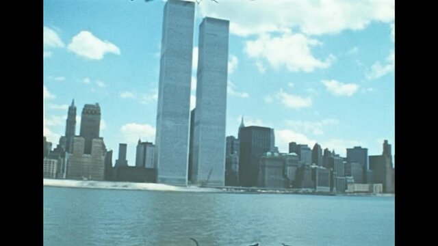 Old Twin Towers skyscrapers and office buildings of New York city. United States America in 1976. Archival of Manhattan skyline, sea view from Hudson river sightseeing cruise.