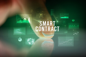 Finger touching tablet with business graphs and icons concept