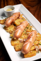 german cheese sausages with fried potato and mustard