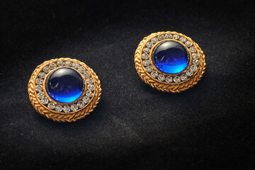 Golden vintage earrings from the eighties with gems inlaid on them