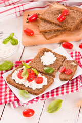 
Rye bread with cottage cheese, basil and tomato.

