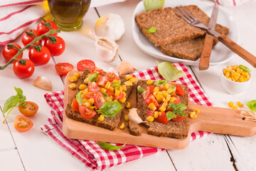 Rye bread withsweet corn, basil and tomato.