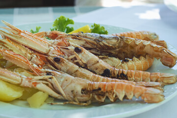 Delicious Croatia seafood platter - grilled langoustine shrimps from fresh catch of the day