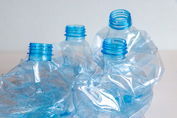Crushed or crumpled clear plastic bottles. Plastic waste. Plastic recycling. Plastic pollution and waste management. 