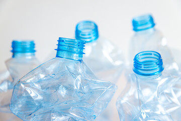 Crushed or crumpled clear plastic bottles. Plastic waste. Plastic recycling. Plastic pollution and waste management. 