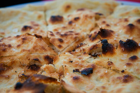 Traditional Croatian rustic bread - close up of a flatbread pita with salt, garlic and olive oil