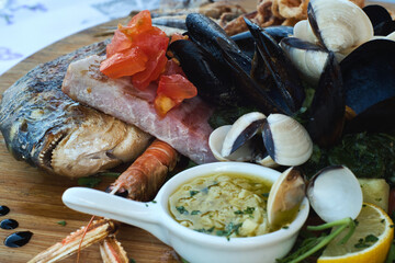 Seafood platter of delicious Adriatic catch of the day - lobster, prawns, shrimps, mussels, shells, fresh dorado fish, anchovies and seabass with hot garlic sauce