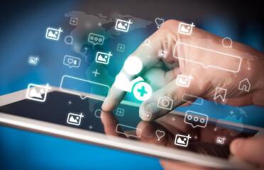 Close-up of a hand using tablet, social media concept