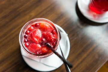 A berry drink with strawberries on the table