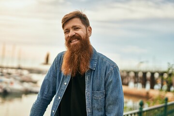 Young irish hipster man smiling happy standing at the city.