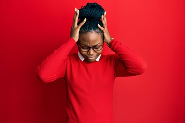 Young african american woman wearing casual clothes and glasses suffering from headache desperate and stressed because pain and migraine. hands on head.