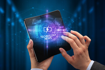 Businessman holding a foldable smartphone, technology concept