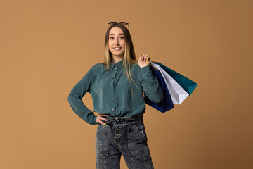 Fototapeta premium happy woman holding shopping bags with purchases