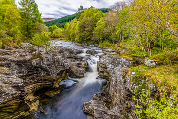 Fototapeta na wymiar A long exposure view of the falls at Invermoriston, Scotland on a summers day