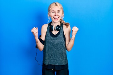 Beautiful caucasian woman with blond hair wearing sportswear celebrating surprised and amazed for...