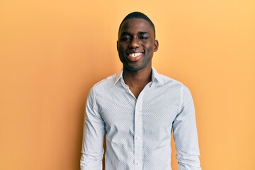 Young african american man wearing casual clothes with a happy and cool smile on face. lucky person.