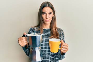 Young beautiful woman drinking italian coffee skeptic and nervous, frowning upset because of problem. negative person.