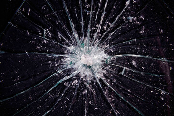 A broken glass, with a big hole in the center, and many sharp shards.

