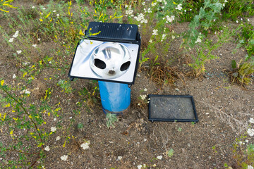 floodlight for external lighting of the building. broken lantern fixed to the ground.