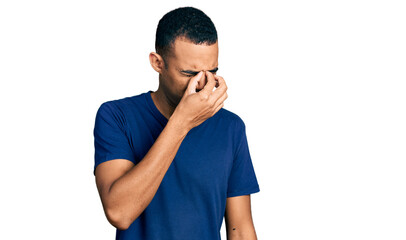 Young african american man wearing casual t shirt tired rubbing nose and eyes feeling fatigue and headache. stress and frustration concept.