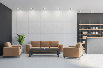 Reception area with light brown sofa, armchairs besides