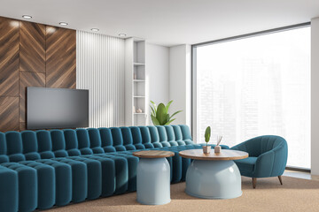 Corner view of the living room with television, blue sofa, panoramic windows