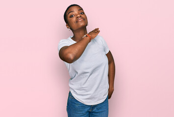 Young african american woman wearing casual white t shirt cutting throat with hand as knife,...