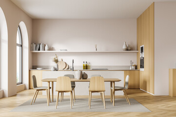 Front view of the light beige kitchen with arch window, table