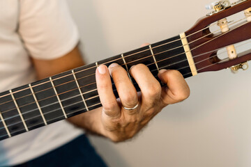 Fototapeta na wymiar Guitar chord, C major chord. Male hand playing guitar chord