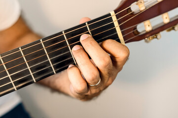 Guitar chord, A minor chord, Am.
Male hand playing guitar chord