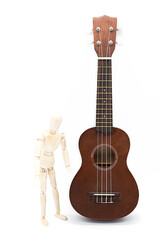 Ukulele acoustic guitar with human mannequin figure . Break time for hobby. Art or musical concept. Brown hawaiian guitar and wooden puppet white background.