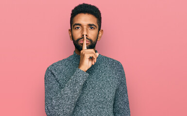 Young african american man wearing casual clothes asking to be quiet with finger on lips. silence and secret concept.