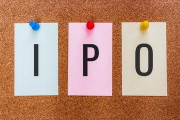 Conceptual 3 letters abbreviation IPO(initial public offering, or stock launch) on multicolored stickers attached to a cork board.