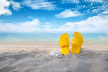 Yellow sandals on the beach and blue sky background-Summer holiday and vacation concept.