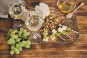 cheese, grapes and wine on wooden background 