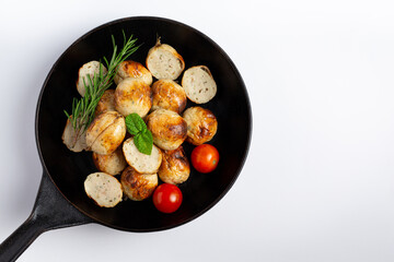 Isan sausages placed on the pan