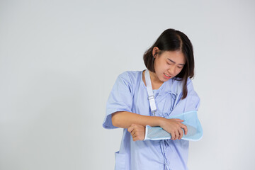 Young woman with a broken arm wearing an arm splint  on white background