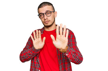 Hispanic young man wearing casual clothes moving away hands palms showing refusal and denial with...
