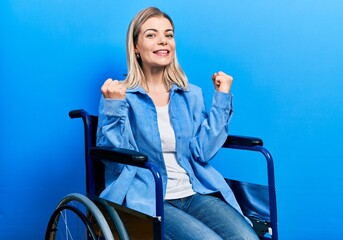 Beautiful caucasian woman sitting on wheelchair excited for success with arms raised and eyes closed celebrating victory smiling. winner concept.