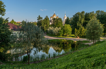 Fototapeta na wymiar Uspensky Cathedral in Dmitrov near Moscow, Russia, in a park with pond