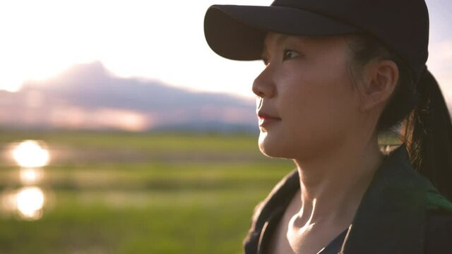 Close up face Young Asian women running with sunset background. Sport Asian girl running at the beautiful sunset. Concept healthy running and outdoor exercise, Tracking shot. 4k Slow motion. 