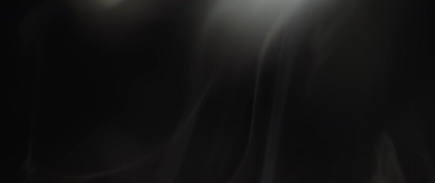 White incense smoke swirling on black background in slow motion. 
