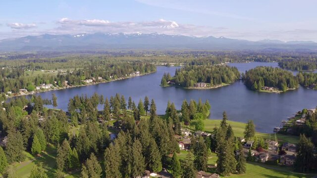 Flying Sideways Left to Right Looking at Mount Rainier and Houses on an Island on Lake Tapps