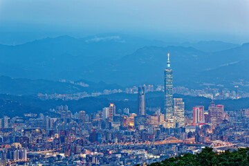 Panoramic aerial view of crowded Taipei City, Taipei 101, XinYi Commercial District, Keelung River and downtown area at moody dusk ~ Taipei City skyline in evening twilight