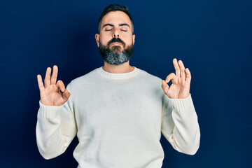 Young hispanic man wearing casual clothes relax and smiling with eyes closed doing meditation gesture with fingers. yoga concept.