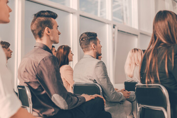 young people listening to the speaker at the business seminar