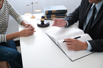Legal counsel presents to the client a signed contract with gavel and legal law. justice and lawyer...
