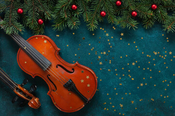 Fototapeta na wymiar Two Old violins and fir-tree branches with Christmas decor wits glitter