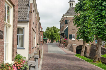 Nieuwpoort, The Netherlands, July 16, 2021: main street in the fortified old town with traditional houses and the former town hall